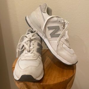 New Balance 574 white and grey sneakers.